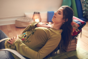 Attractive mixed race woman doing restorative yoga